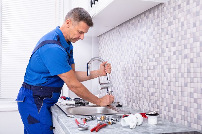 Handyman Repairing a Faucet